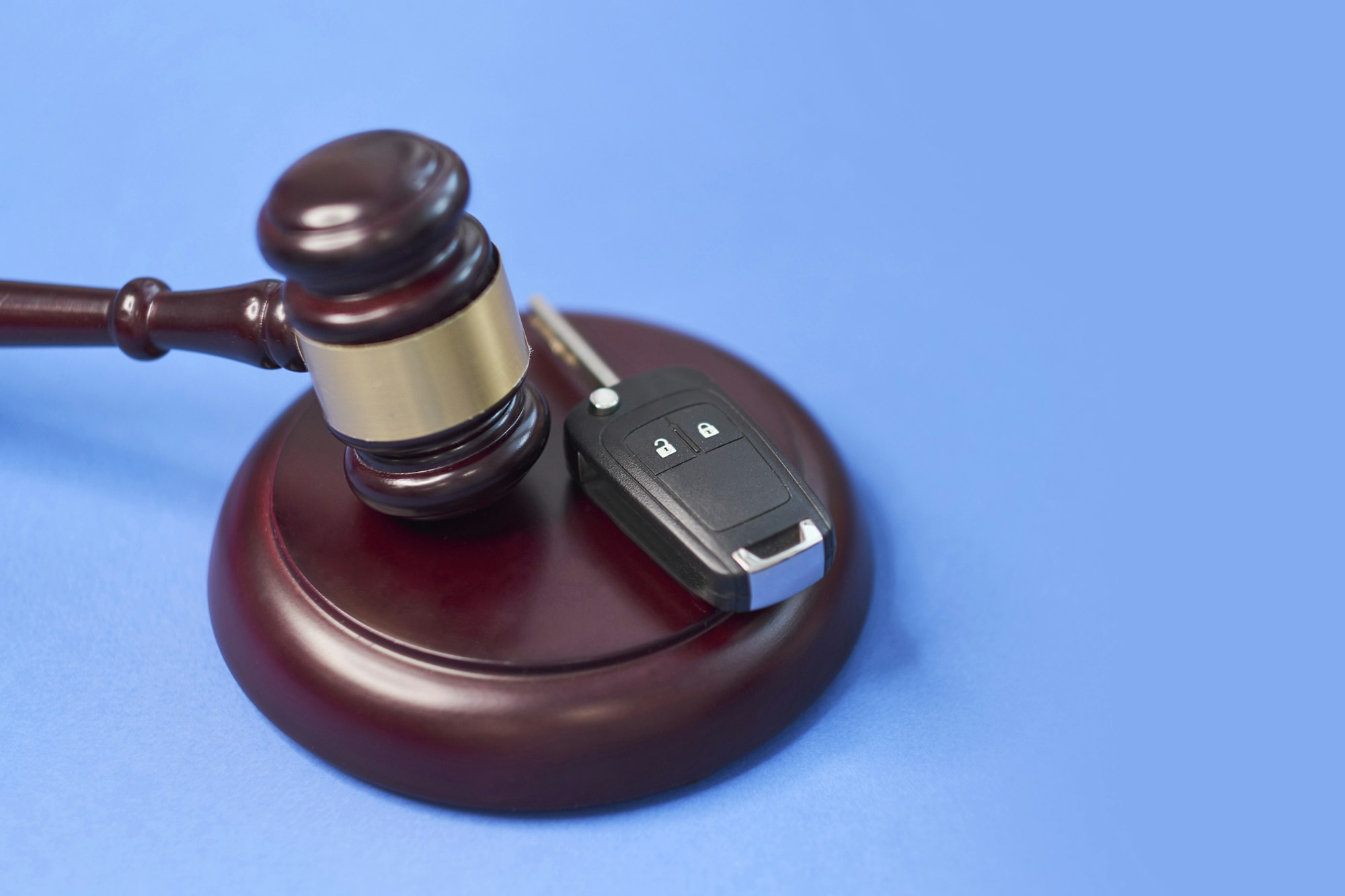 Driver license revocation concept next to the judge hammer.