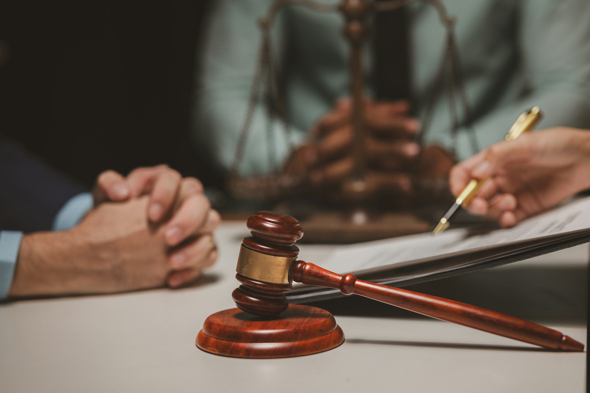 A group of lawyers and clients are discussing the contract they will be signing together in the futu