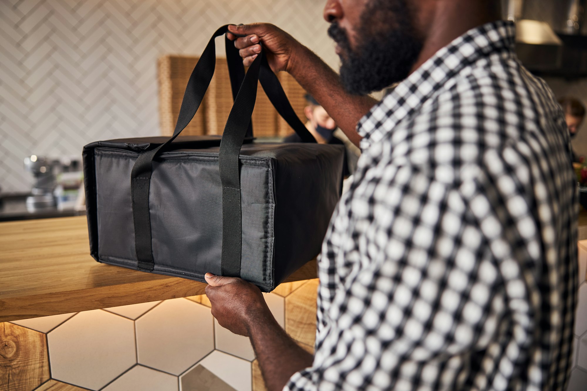 Afro American young man grabbing food delivery bag