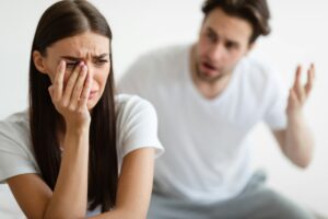 Aggressive Husband Shouting At Unhappy Crying Wife At Home