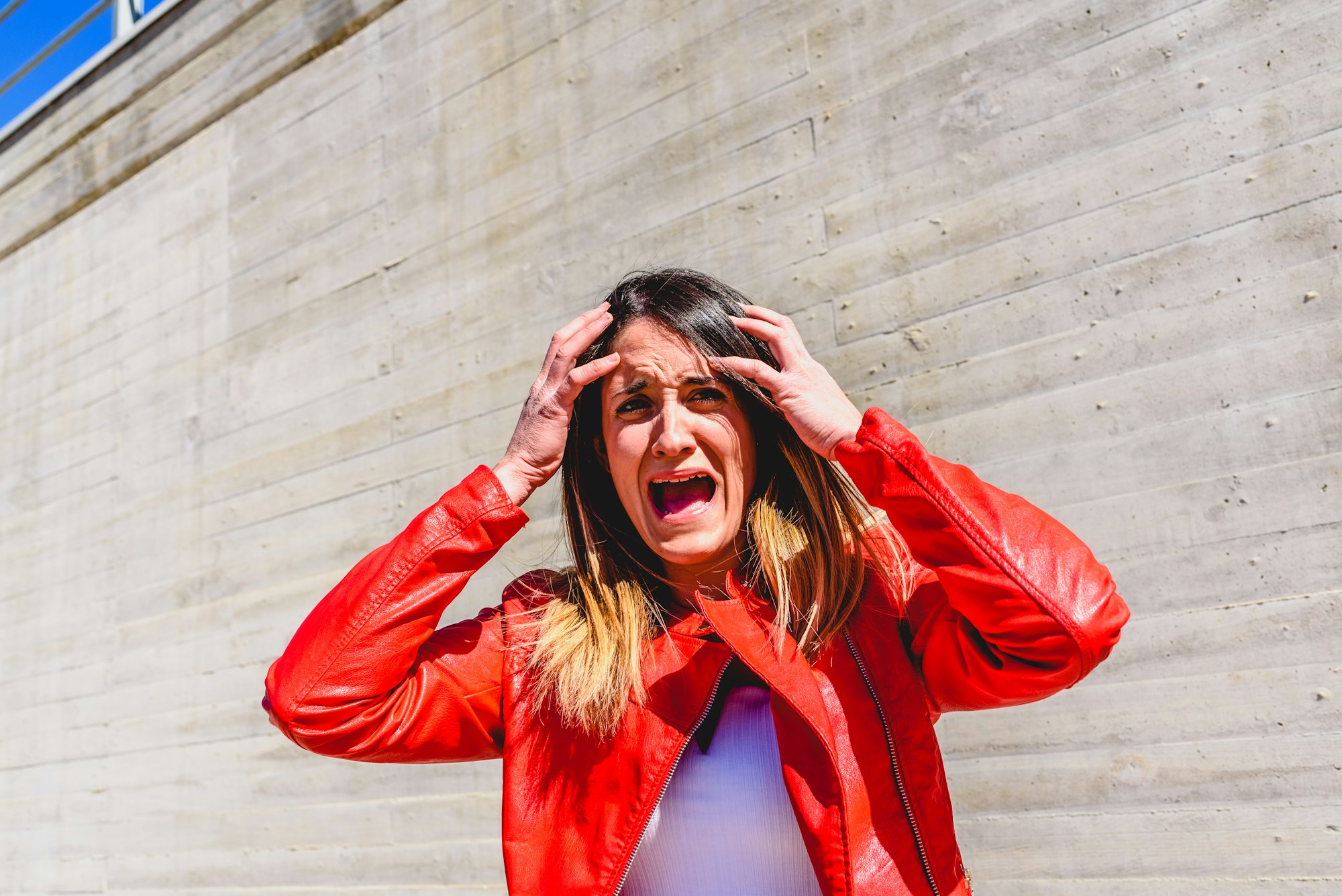 Frightened young woman gesturing with fear after a robbery.