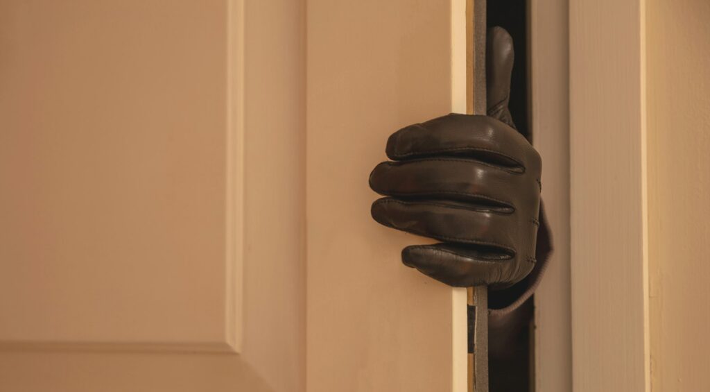 Gloved hand opening the door, Housebreaking, burglary concept