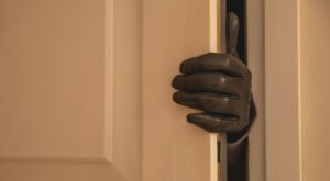Gloved hand opening the door, Housebreaking, burglary concept