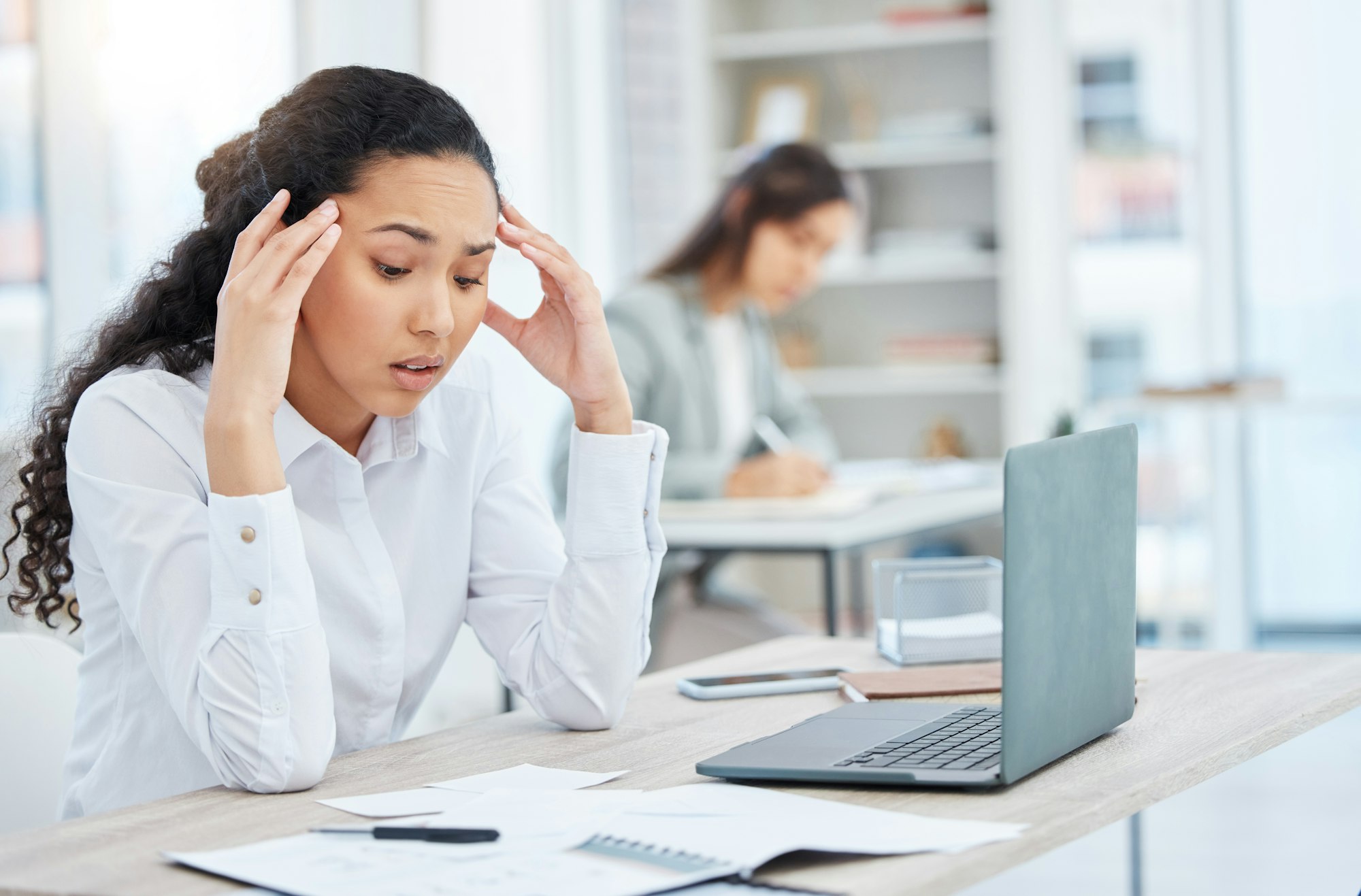 I dont know what this is. Shot of a young businesswoman looking overwhelmed in an office at work.