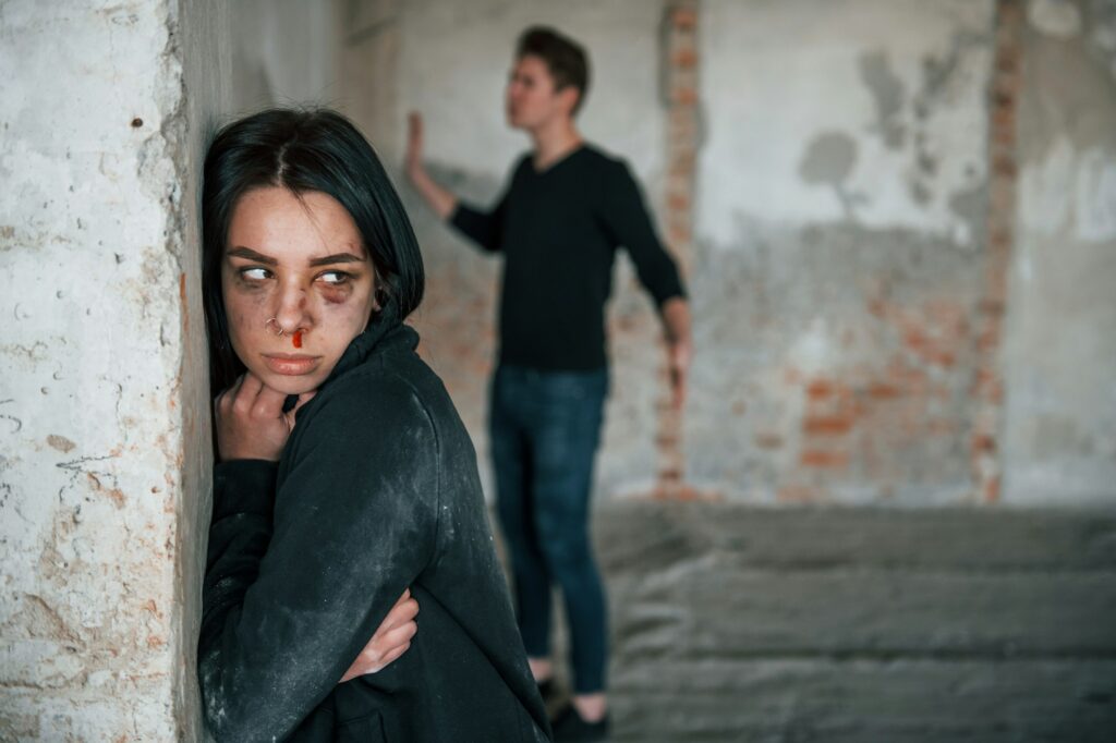 Kidnapped woman is threatened by man in abandoned building