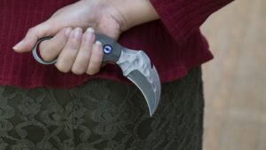 Knife in the hands, karambit knife tactical fighter, self defense Martial Arts Fighting