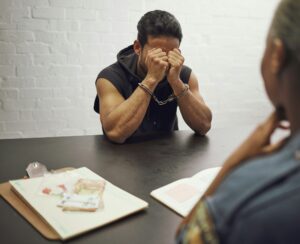 Man, criminal and police interrogation for drugs, crime or money laundering in fear of arrest. Sad