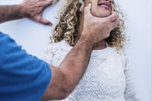 Man hold woman against the wall at home ready to beat up her in abuse violence aggression
