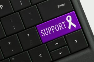 Online help Support Concept - keyboard with PURPLE support awareness ribbon key button.