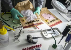Police scientist holds evidence bag with underwear of sexual assault victim