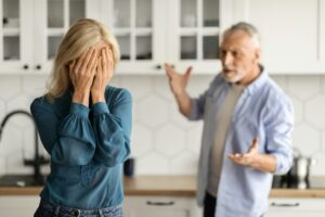 Psychological Abuse. Upset Senior Woman Crying In Kitchen While Arguing With Husband