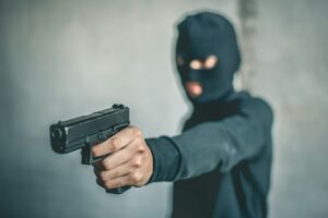 Robber with a gun robbing intimidate.Crime and robbery concept.