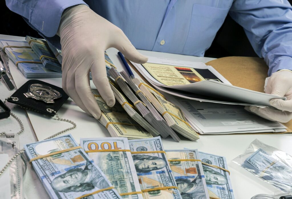 Specialised police officer notes dollar banknote reference of a robbery