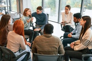 Supporting the woman. Group of people are having therapy meeting together
