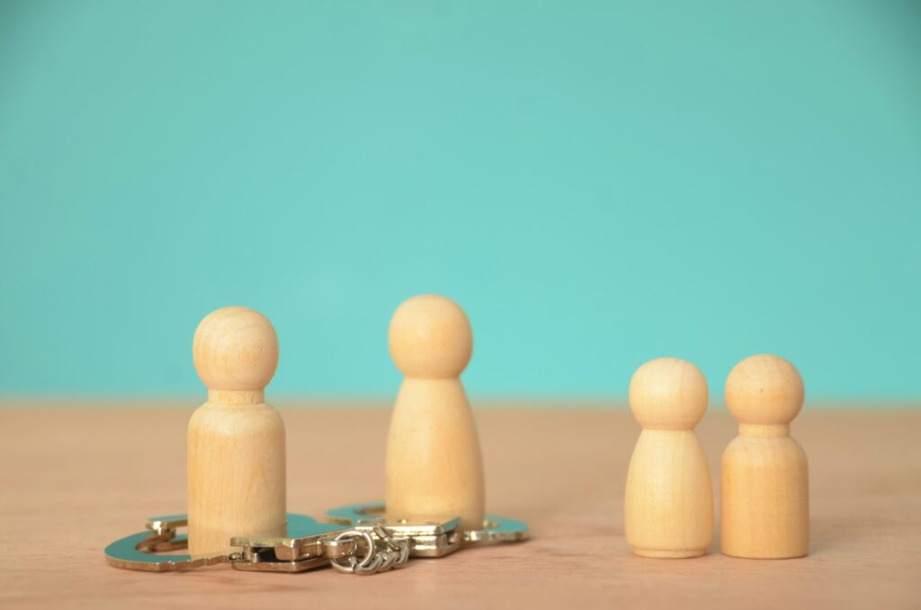 the potential conflict or division,represented handcuffs restraining two members the family group