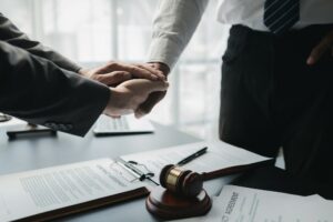 Two lawyers shake hands in a brainstorming meeting. Lawyers search for legal information together to