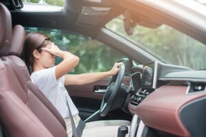 woman feeling stress and angry during drive car long time. Asian girl tired and fatigue having heada