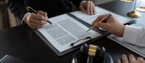 Businessmen and lawyers or legal advisors discuss legal treaty contract documents before signing con