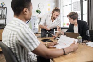 Multiracial partners during working process indoors.