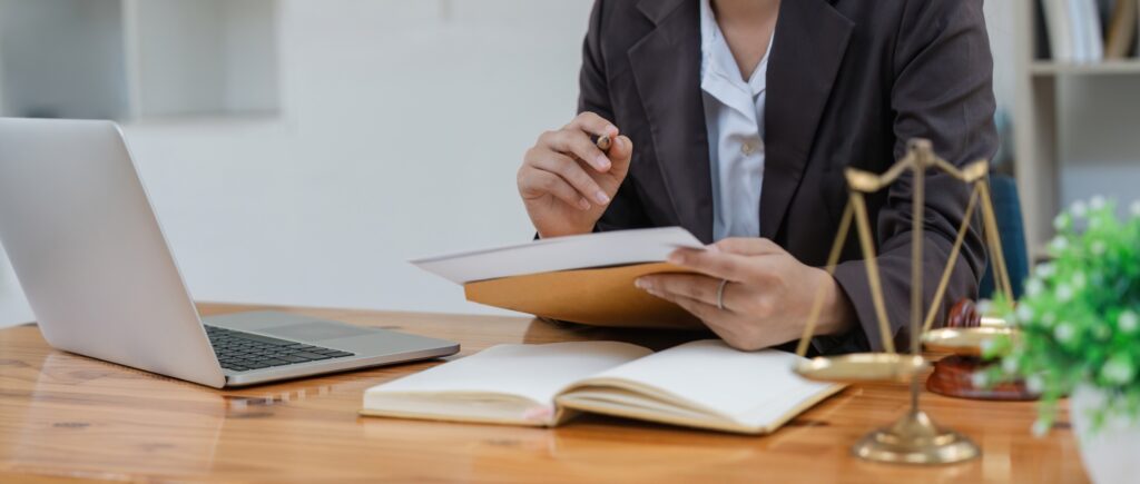 Young female lawyer asian people in real estate working law book and contract documents Arguments