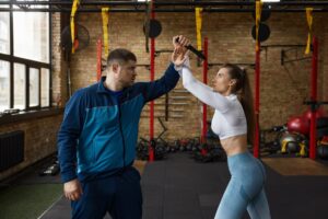 Young sportive woman practicing self-defense from knife with coach