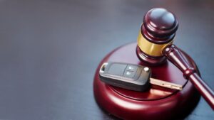 Driver license revocation concept next to the judge hammer.