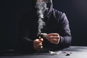 Drug addict man or drug dealer prepares heroin.