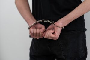 Man's Hands In Handcuffs. criminal