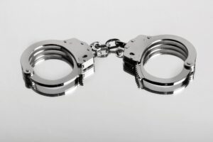 Studio close-up of a locked pair of hiatt type handcuffs