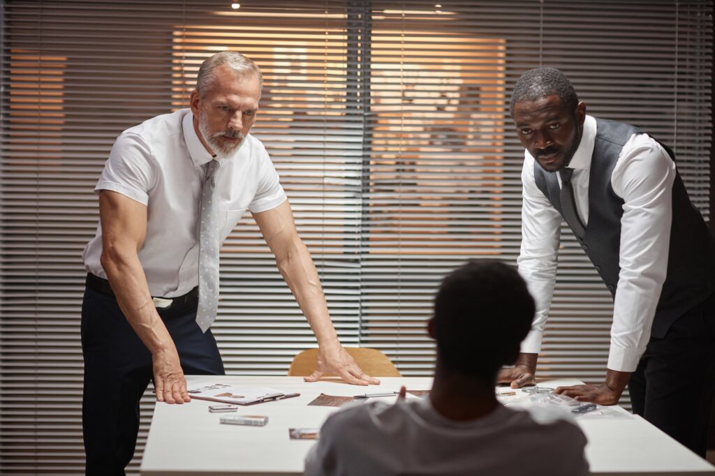 Two detectives interrogating suspect in criminal case