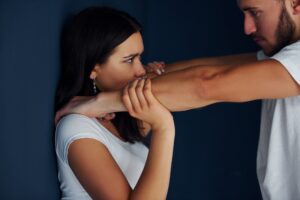 Violent aggressive young man beats his girlfriend at home