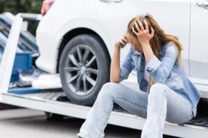 woman calling roadside car broken for need help while towing service assistance moving her car out