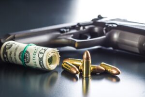 9 mm bullets, dollars and handgun.