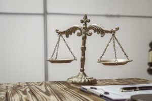 A businessman in a formal suit signs a contract, hands close up, suggesting possible bribery