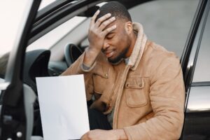 Black man with impression of embarrassment on his face