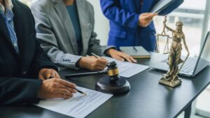 Business lawyer team working with law firms contracts in working room.