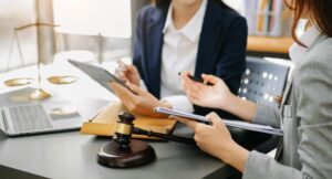 business people and lawyers discussing contract papers sitting at the table.