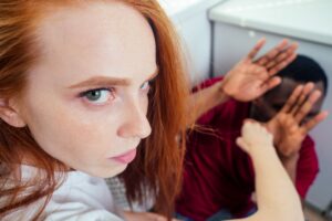 domestic violence. angry girl hitting african american man at kitchen