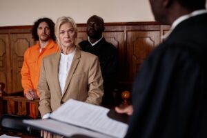 Focus on mature female attorney listening to impartial judge with open folder