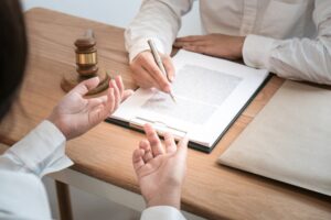 Legal counsel presents to tthe client a signed contract with gavel and legal law. justice and lawyer