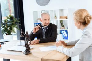 mature lawyers discussing documents in office