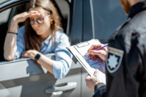 Policeman issuing a fine for a female driver