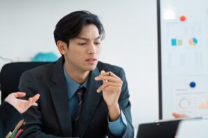 Thoughtful business professional analyzing reports during a meeting in the office.