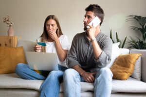 Couple having financial problems calling bank. Victims of fraud.