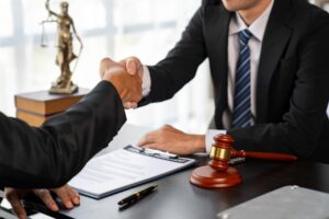 Lawyers shake hands with business people to seal a deal with partner lawyers. or a lawyer discussing