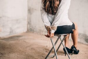 woman hands bound. Women were handcuffed and Sitting on a chair.woman tied hand to a chair. Crime