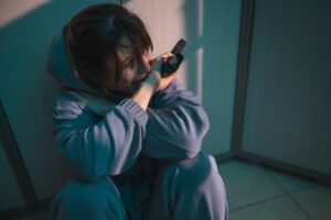 Woman holding a gun crying after committing murder