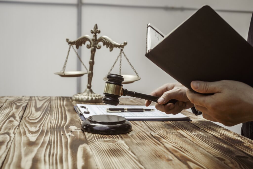 A businessman in a formal suit signs a contract, hands close up, suggesting possible bribery