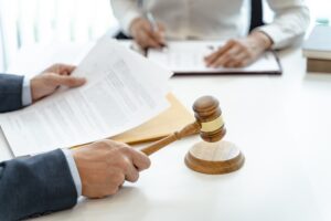 Lawyer Legal counsel presents to the client a signed contract with gavel and legal law