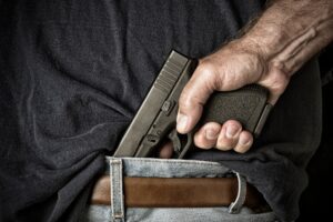 Man pulling gun from waistband